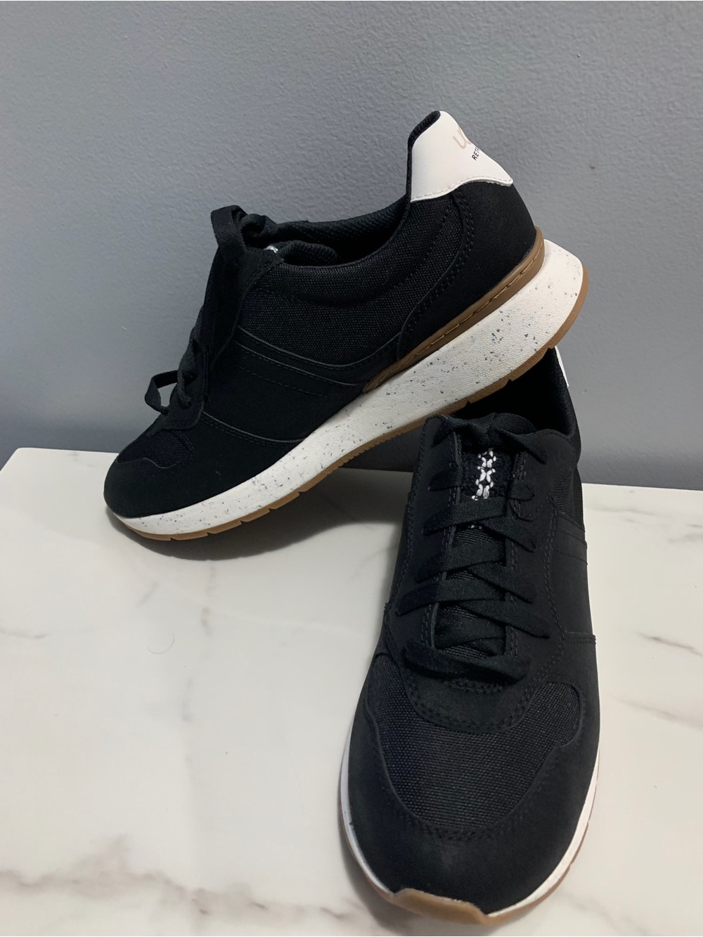 UGG women’s Black retrainer Casual Sneakers with White & Gum Sole